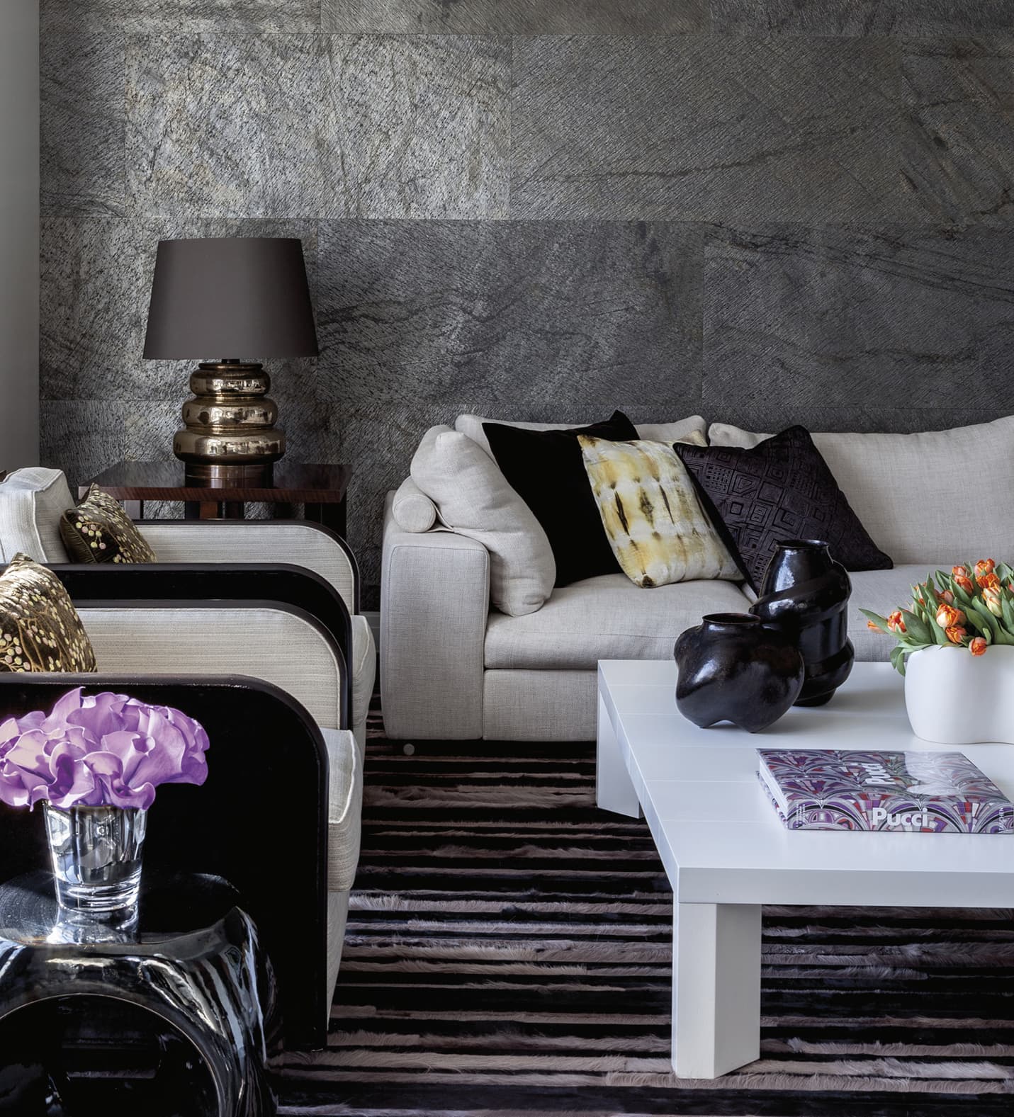 Sitting area with grey textured walls and white coffee table