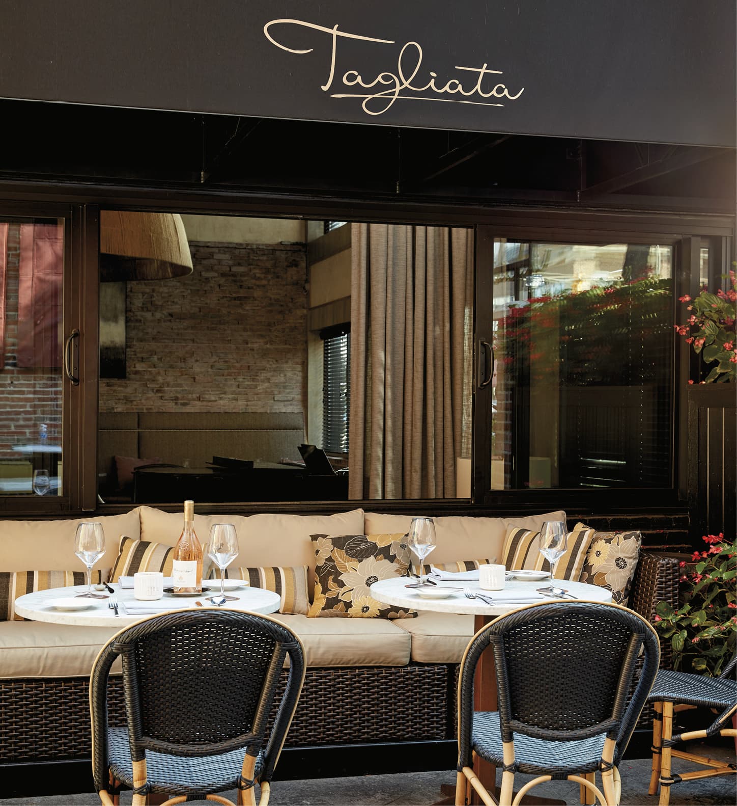Awning of the Tagliata restaurant with tables underneath